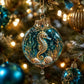 Seahorse-themed crystal ornament with teal glitter, gold filigree top, and hanging loop