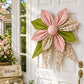 Quilted bow wall decor with pink floral petals, green leaves, and round fabric center