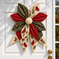 Quilted bow with red and green floral leaf petals, cream accents, and round padded center