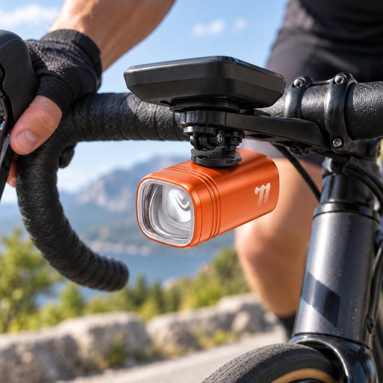Orange bike headlight with front mount bracket and clear LED lens on handlebar
