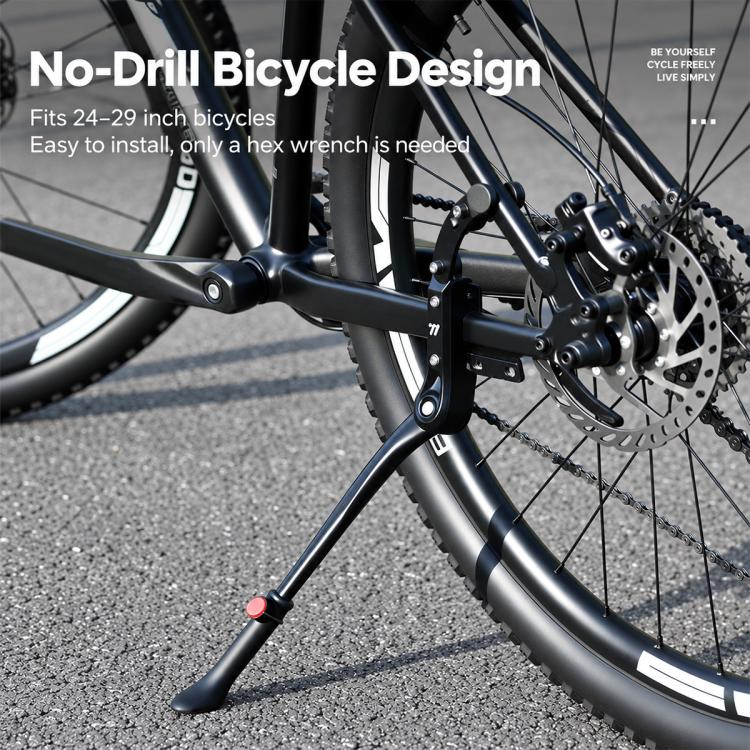 Kickstand installed beside mountain bike rear wheel on black frame support