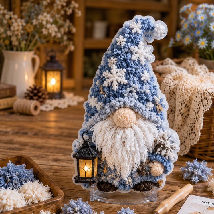 3D fabric poke art gnome with blue textured hat and white beard with lantern