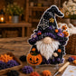 3D fabric poke art gnome with black hat, white beard, and pumpkin and spiderweb motifs