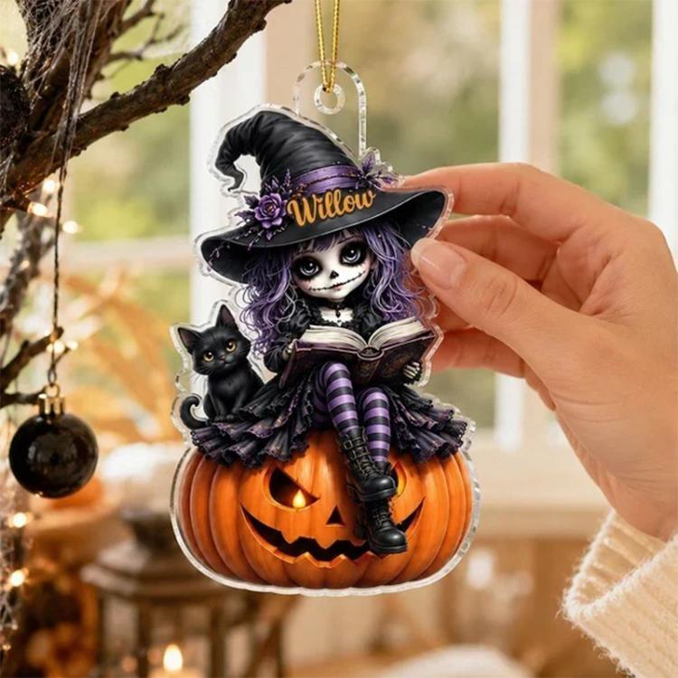 Hand holding Halloween witch acrylic hanging ornament with jack-o-lantern pumpkin and cat