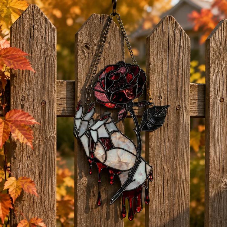Fence-hung thorny rose sun catcher ornament with skull rose motif in black and red