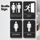 Set of black tactile Braille signs showing RESTROOM, EXIT, WOMEN, and MEN symbols.