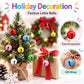 Small round bell charms hanging on a decorated Christmas tree and gift wrap
