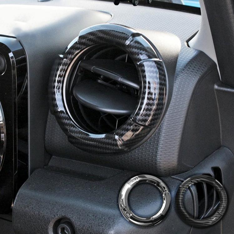 Carbon fiber and chrome circular AC vent trim sticker rings on dashboard
