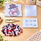 Snowman fuse bead template board with red hat and multicolor beads and guide card