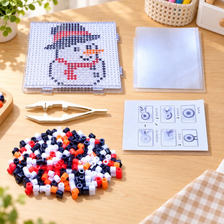 Snowman fuse bead template board with red hat and multicolor beads and guide card