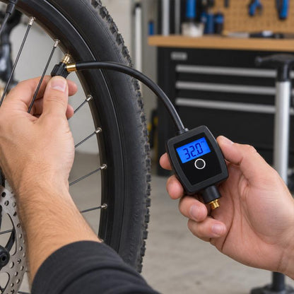 Digital tire pressure gauge with blue LCD reading, held to bicycle tire valve