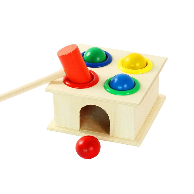 Wooden knocking table with red mallet, red ball, and four colored buttons