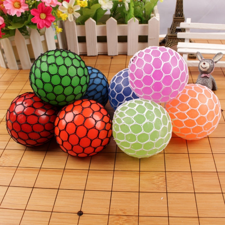 Set of anti-stress grape squeeze balls: green, blue, pink, orange, red on wooden floor