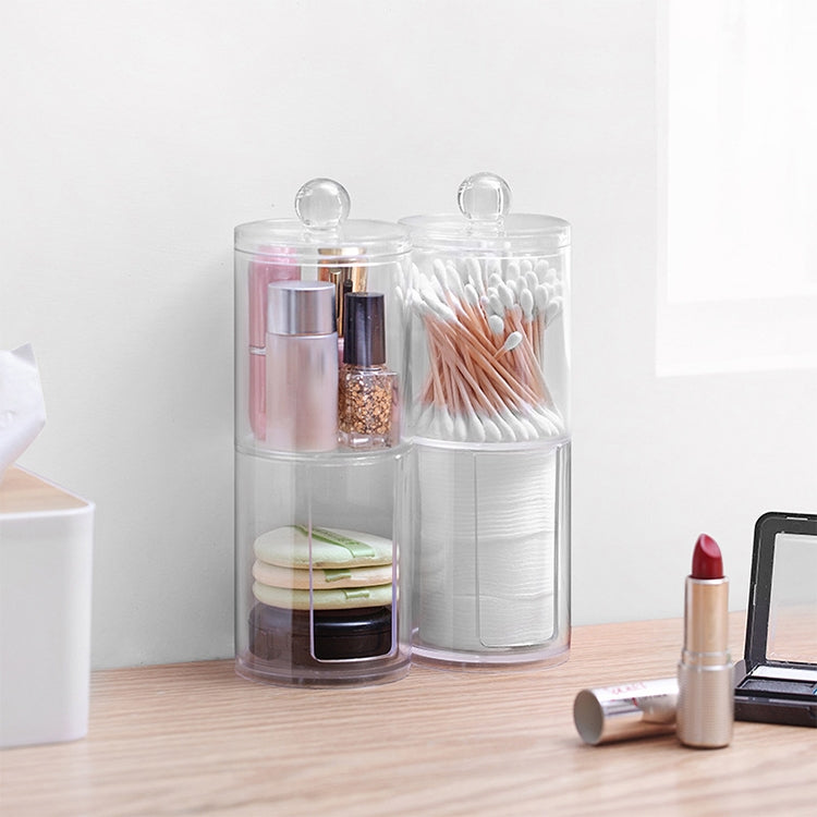 Clear round plastic cosmetic box with two clear compartments for swabs and cotton pads.