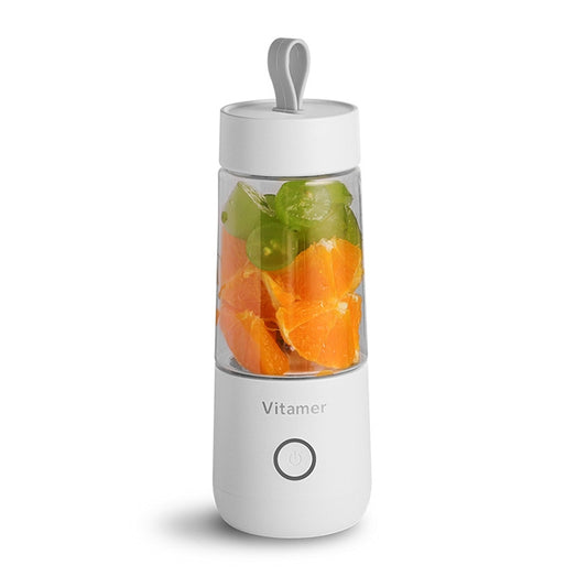 Vitamer white portable blender bottle filled with orange and green fruit pieces