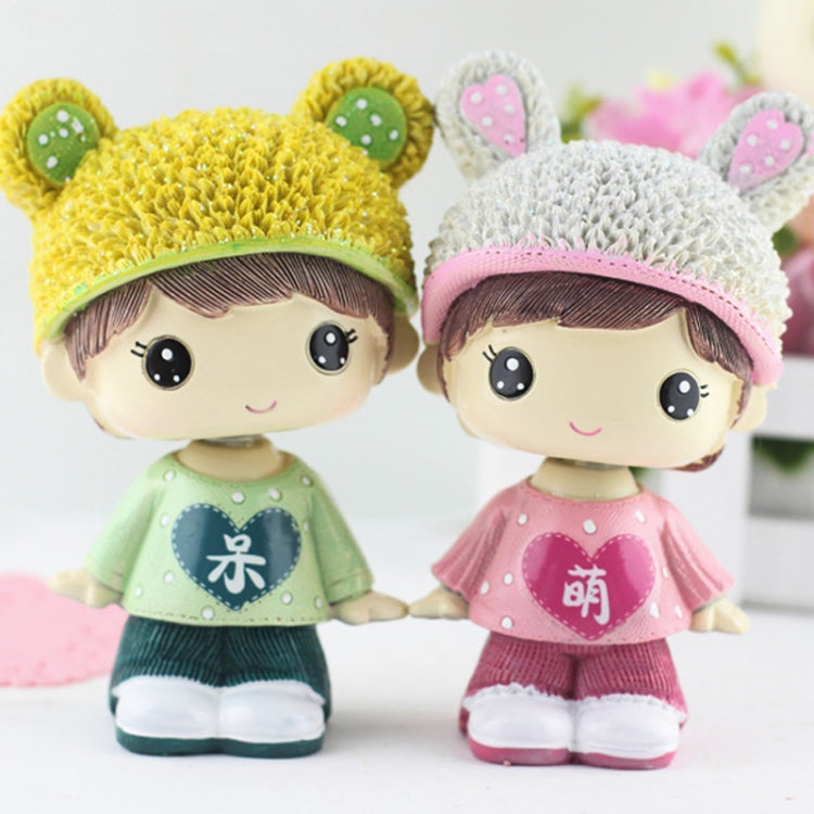 Resin cartoon couple ornament, front view: yellow and white bear-hat figures in green and pink
