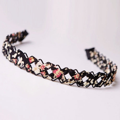 Black hollow braid hair hoop headband with multicolor floral patches, coiled ring.