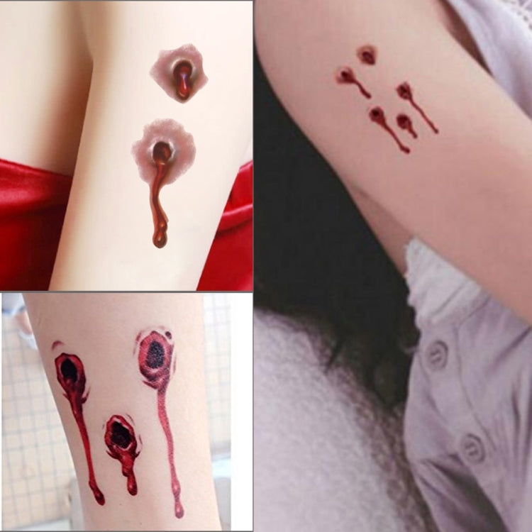 Realistic bullet wound blood temporary tattoos applied on forearm with drips