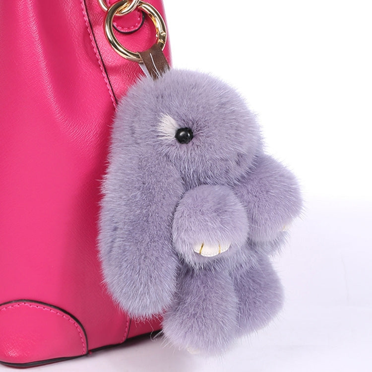 Lavender rex rabbit plush keychain pendant attached to a pink bag loop