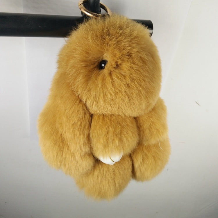 Golden yellow rex rabbit plush keychain pendant hanging from a black strap