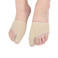 Two beige toe correction sleeves worn on both feet, covering big toe area.