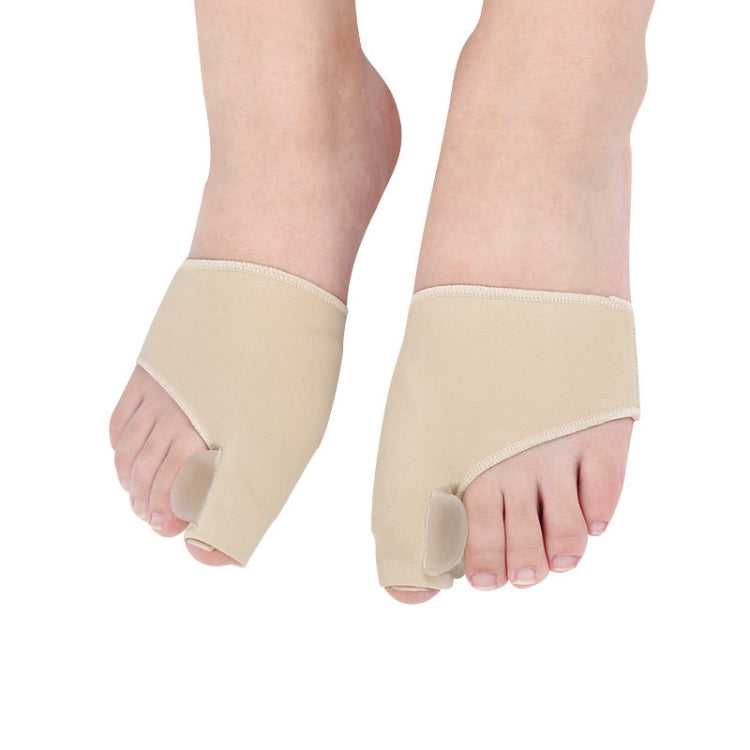 Two beige toe correction sleeves worn on both feet, covering big toe area.