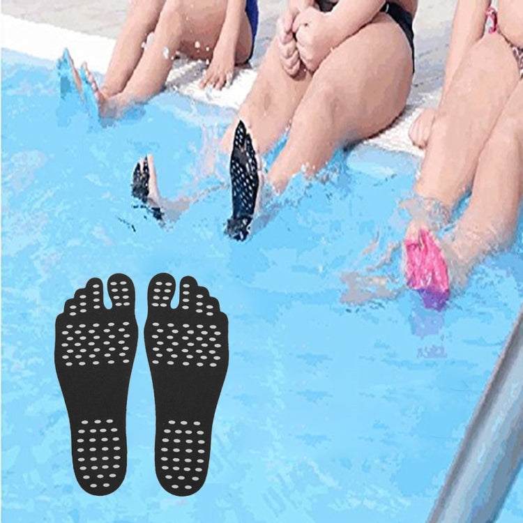 Black anti-slip sandal insoles with dotted grip texture shown on beach sand