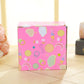 Decorative gift box labeled Happy, pink with multi-color circle and heart prints