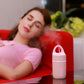 Mini portable humidifier on bedside table, white with blue LED strip and mist