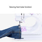 Sewing machine front showing tube attachment for sewing hems or pant legs