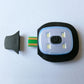 LED light module with power button and connector piece on a black base