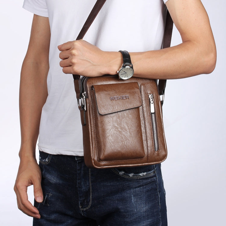 Brown leather-look messenger bag with front flap pocket and zip compartments, worn crossbody