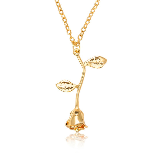 Gold-tone pendant necklace with branching floral charms and leaf details on a link chain