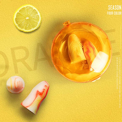 Orange earplug case with two white foam earplugs for sleep protection