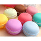 Assorted pastel macaron-shaped storage boxes arranged in a cluster