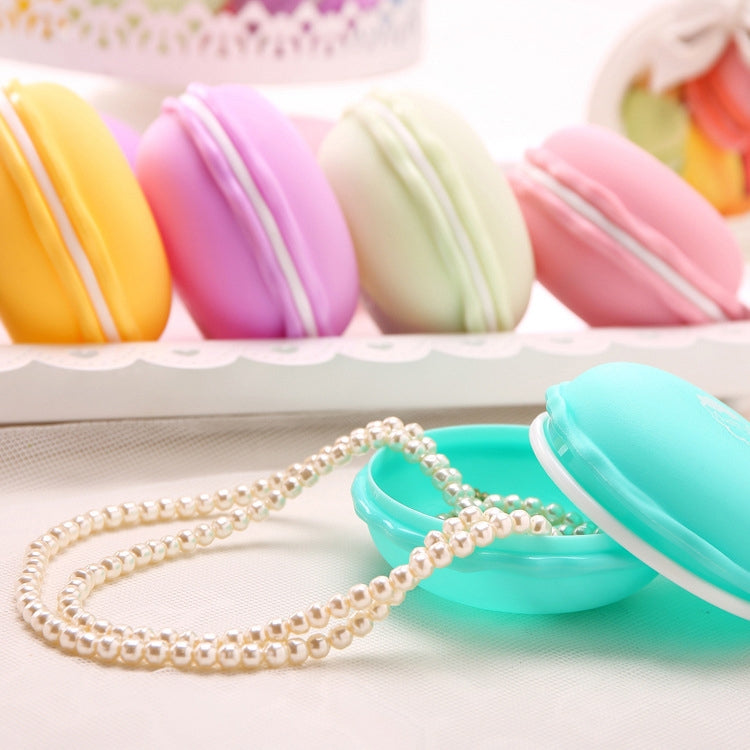 Macaron-style storage boxes with pearl beaded necklace in foreground