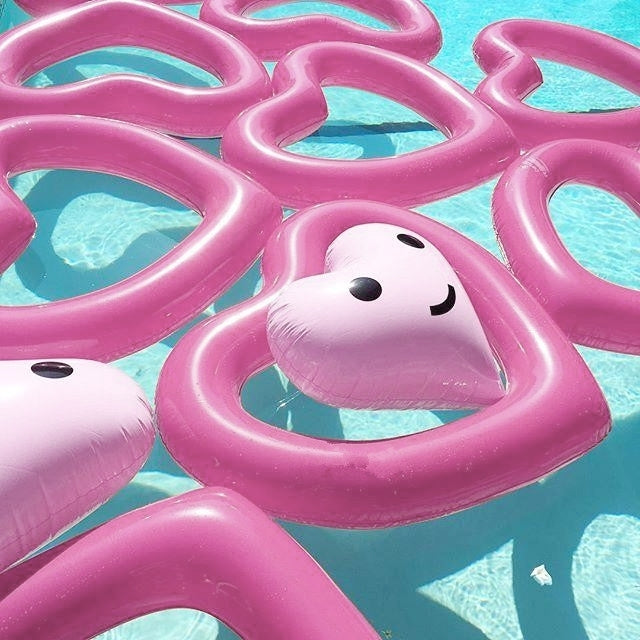 Stack of pink heart-shaped inflatable pool rings with multiple inner heart openings