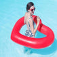 Red heart-shaped inflatable pool safety ring floating under a person