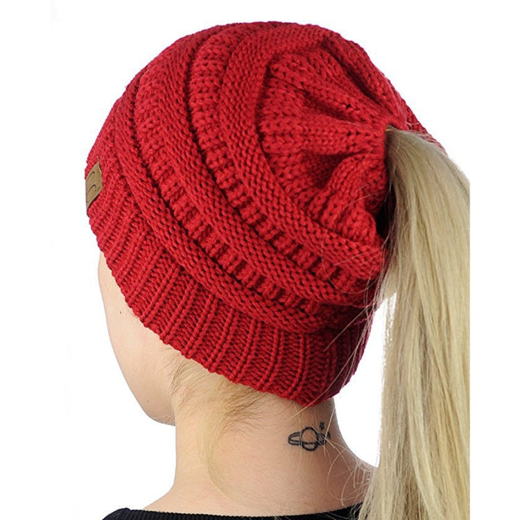 Red knitted ponytail cap beanie with ribbed hem and textured stitch pattern
