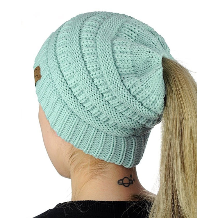 Light aqua knitted ponytail cap beanie with ribbed trim and chunky cable texture