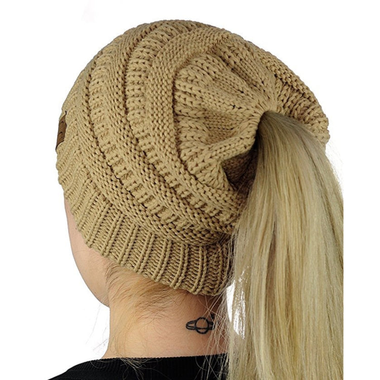 Tan/brown knitted ponytail cap beanie with ribbed hem and thick braided knit
