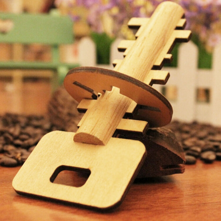 Wooden lock-unlock puzzle key with removable pieces, natural wood and dark openings