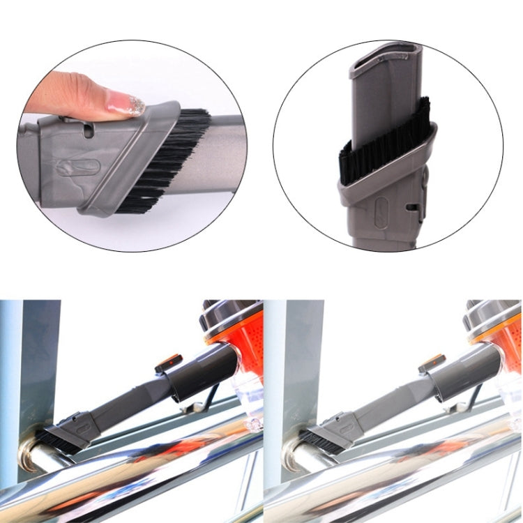 Grey vacuum brush attachment with black bristles and angled head, close-up detail