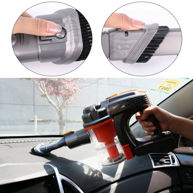 Vacuum cleaner brush attachment in use on car window, hand holding the handle