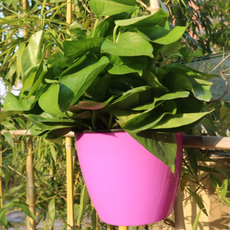 Self-watering wall-hanging planter pot, pink round resin with leafy plant