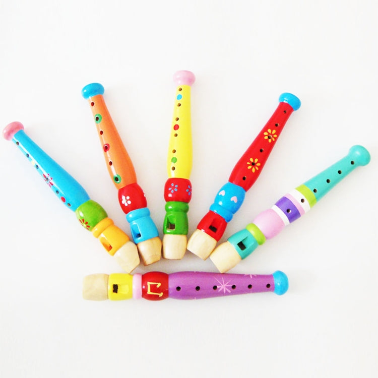 Colorful wooden toy flutes with painted bodies and finger holes