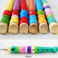 Close-up of colorful wooden toy flutes, painted tops and natural wood ends