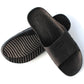 Black slide slippers with textured outsole tread and six-hole upper design
