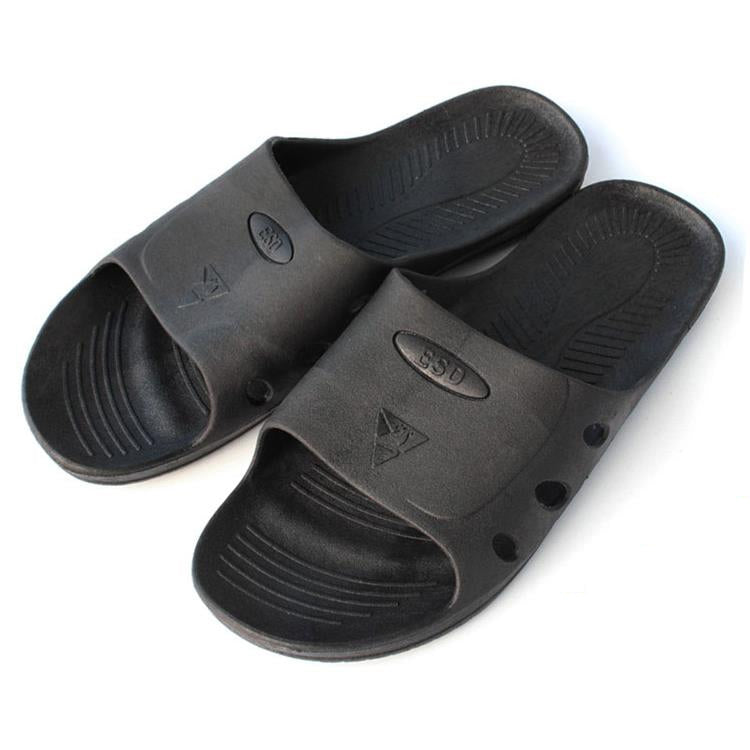 Black six-hole slide slippers showing footbed texture and perforated strap details