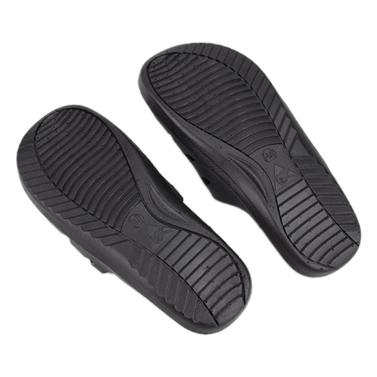Pair of black slide slippers showing grippy outsole tread pattern
